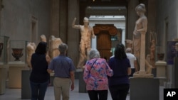 Visitors tour The Metropolitan Museum of Art during a preview in advance of its reopening, Aug. 27, 2020, in New York.