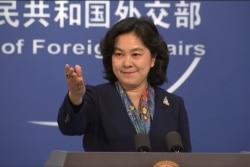 China's Foreign Ministry spokesperson Hua Chunying gestures during a press conference in Beijing on Dec. 10, 2020.