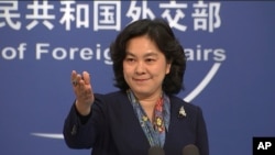 China's Foreign Ministry spokesperson Hua Chunying gestures during a press conference in Beijing on Dec. 10, 2020. 