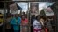 Mourners line up after waiting for hours to get into a bus to go to the Union Buildings where the casket of Nelson Mandela lies in state for three days in Pretoria, Dec. 11, 2013.