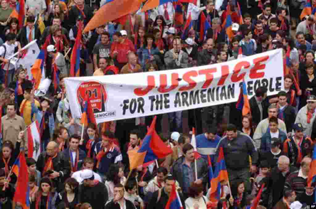 Lebanese Armenians wave a banner and hold Armenian flags as they march on the main coastal highway in Beirut, Lebanon, Monday, April 24, 2006, to mark the 91th anniversary of massacres in Turkey that began in April 1915 and in which hundreds of thousands 