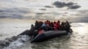 Migrants board a smuggler's boat in an attempt to cross the English Channel, near Dunkirk, France, on April 26, 2024. A human rights group announced on May 3 that it will ask the courts to stop the U.K.'s plan to send asylum seekers to Rwanda.