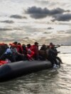 Migrants board a smuggler's boat in an attempt to cross the English Channel, near Dunkirk, France, on April 26, 2024. A human rights group announced on May 3 that it will ask the courts to stop the U.K.'s plan to send asylum seekers to Rwanda.