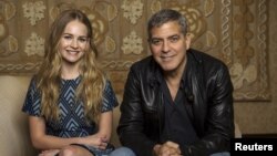 Cast members George Clooney and Britt Robertson pose for a portrait while promoting their upcoming movie "Tomorrowland" in Beverly Hills, California, May 8, 2015. 