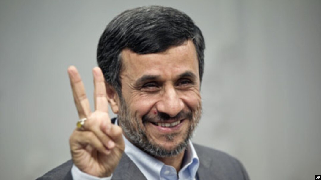 Iranian President Mahmoud Ahmadinejad gestures to the media as he attends for an official meeting with Qatar's Foreign Minister Adviser Khalid Mohammad al-Atiyeh, in Tehran, October 13, 2011.