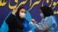FILE - Sara Goudarzi, a nurse from the Imam Khomeini Hospital, flashes a victory sign as she receives a Russian Sputnik V coronavirus vaccine in a staged event at Imam Khomeini Hospital in Tehran, Iran, Feb. 9, 2021. 