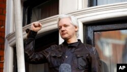 FILE - Julian Assange greets supporters outside the Ecuadorian embassy in London, May 19, 2017.