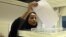 A Saudi woman casts her ballot at a polling center during municipal elections in Riyadh, Saudi Arabia, Dec. 12, 2015.