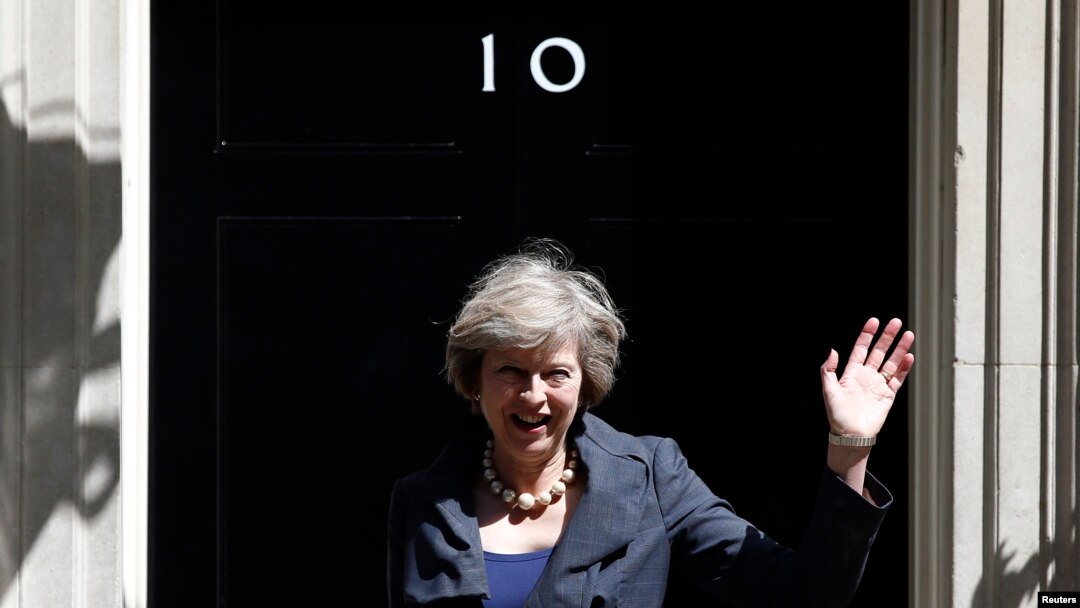 Britain's new Prime Minister Theresa May waves as she leaves after a Cabinet meeting at number 10 Downing Street in central London on July 12, 2016. 