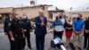 President Donald Trump talks to business owners, Sept. 1, 2020, as he tours an area damaged during demonstrations after a police officer shot Jacob Blake in Kenosha, Wis.