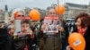 Attendees hold portrait placards of Israeli hostages Guy Gilboa-Dadal, Kifr Bibas, Ariel Bibas, Shiri Bibas and Yarden Bibas reading "kidnapped on October 7" during a gathering in tribute to Israeli hostages, called by the Representative Council of French