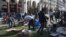 Migrants clear the Aristotelous Square in the northern Greek city of Thessaloniki, Oct. 8, 2018. Several hundred asylum-seekers camped outside a police station in Greece's second-largest city, lining up to be arrested and formally processed, as a surge in illegal migration in northern Greece has overwhelmed authorities.