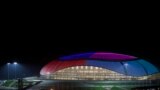 The Bolshoy Ice Dome illuminated at night in Sochi.