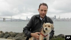 FILE: FILE - In this May 16, 2011 file photo Timothy Ray Brown poses in San Francisco. Brown, who made history as “the Berlin patient,” the first person known to be cured of HIV infection, died Tuesday, Sept. 29, 2020, at his home in Palm Springs, Calif. He was 54. 