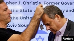 FILE — Former New Jersey Governor Chris Christie receives a dog tag with the words "Bring them home" on it from a family member of a hostage held by the Palestinian Islamist group Hamas, during a visit at Sourasky Medical Center (Ichilov) in Tel Aviv, Israel November 12, 2023.