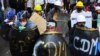 Protesters take cover behind homemade shields during a demonstration against the military coup in Yangon, Myanmar.