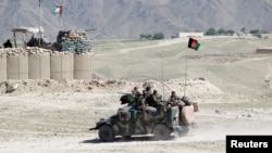 FILE - Afghan special forces patrol in Pandola village near the site of a U.S. bombing in the Achin district of Nangarhar province in eastern Afghanistan April 14, 2017. 