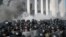 Smoke rises outside Ukraine's parliament building as riot police clash with nationalist protesters, in Kyiv, Aug. 31, 2015.