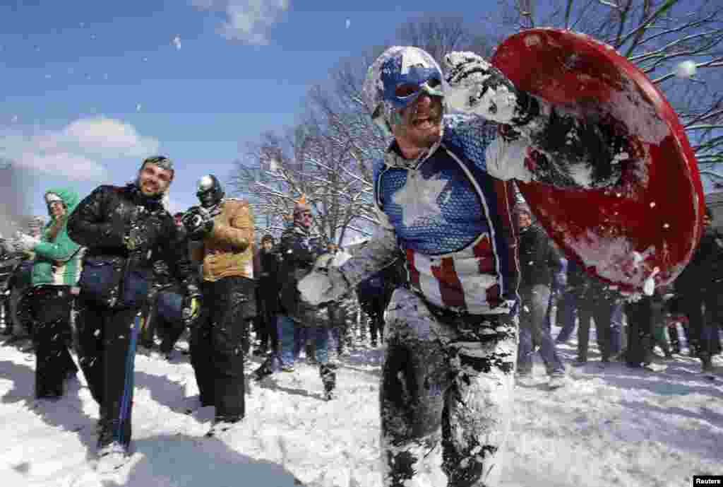 People participate in a massive snowball fight in the wake of winter storm Octavia at Meridian Park in Washington, D.C.