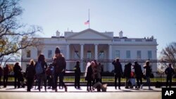 President Barack Obama ordered that flags be lowered at all government buildings — including the White House, above — to honor the victims of the mass shooting in San Bernardino, California, Dec. 3, 2015. 