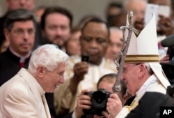 FILE—Pope Francis salutes Pope Emeritus Benedict XVI, left, at the end of a consistory in the St. Peter's Basilica at the Vatican, on February 22, 2014.