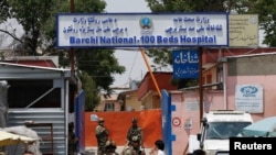 Afghan security forces standing guard outside the Dasht-e-Barchi Hospital which came under attack in Kabul, Afghanistan, May 12, 2020.