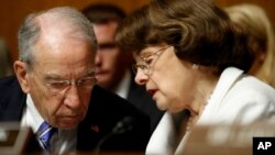 FILE - Senate Judiciary Committee Chairman Sen. Chuck Grassley, R-Iowa, talks with the Committee's ranking member Sen. Dianne Feinstein, D-California, on Capitol Hill in Washington, July 12, 2017. Glenn Simpson, the co-founder of a Washington opposition research firm that produced a dossier of salacious allegations involving President Donald Trump is to be interviewed by the Senate Judiciary Committee Tuesday.