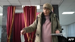 A woman casts her ballot during Belarus' presidential election at a polling station in the capital, Minsk, on Jan. 26, 2025. 