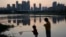 FILE - Children play near the pond at the "Fish Tail" sponge park that's built on a former coal ash dump site in Nanchang in north-central China's Jiangxi province on Oct. 30, 2022.