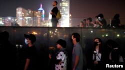 People line up to pay tribute at Tamar Park, outside the Legislative Council (Legco) building, during a prayer and remembrance ceremony in Hong Kong, China, Nov. 9, 2019. 