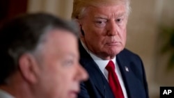 President Donald Trump listens as Colombian President Juan Manuel Santos, left, speaks during a news conference in the East Room of the White House, May 18, 2017, in Washington. 