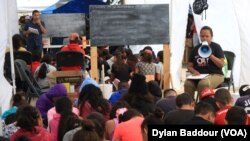 Volunteer teachers give class to children asylum seekers at a tent camp on the US border in Reynosa, Mexico. (Dylan Baddour/VOA)