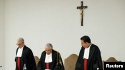 FILE - Judge Giuseppe Pignatone reads the verdict of the Vatican corruption trial, astatine  the Vatican, Dec. 16, 2023.