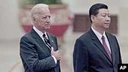 Chinese Vice President Xi Jinping, right, and his U.S. counterpart Joseph Biden listen to national anthems during a welcoming ceremony inside the Great Hall of the People in Beijing, August 18, 2011