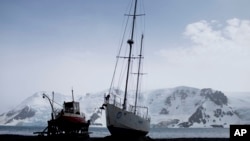 FILE - Most visitors arrive to Antarctica arrive on the Antarctic Peninsula, including the beach at Bahia Almirantazgo, where boats sit, Jan. 27, 2015. The next most popular destination is the Ross Sea on the opposite side of the continent.