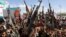 Protesters, largely Houthi supporters, hold rifles as they rally to show solidarity with Palestinians in Gaza, in Sanaa, Yemen, May 10, 2024. 