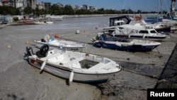 Boats are docked in a small port covered with 'sea snot,' a thick slimy layer of organic matter, also known as marine mucilage, spreading through the Sea of Marmara and posing a threat to marine life, on the shores of Istanbul, Turkey, June 6, 2021. 