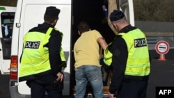 FILE - Police officers check a vehicle during a police operation against immigration, in Biriatou, southwestern France, near the French-Spanish border, on Feb. 18, 2025.