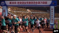 Foreign competitors cross the starting line during the annual 'Mangyongdae Prize International Marathon', at Kim Il Sung stadium in Pyongyang, North Korea, April 7, 2019.