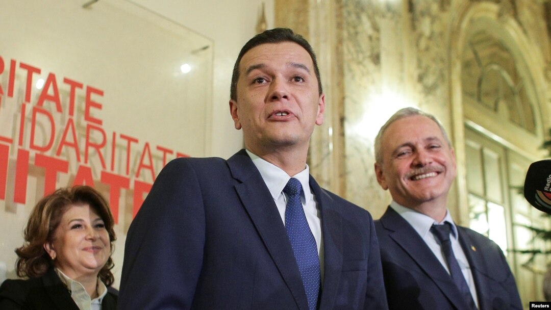 FILE - Sorin Grindeanu, center, answers a question during a press conference in Bucharest, Romania Dec. 28, 2016.