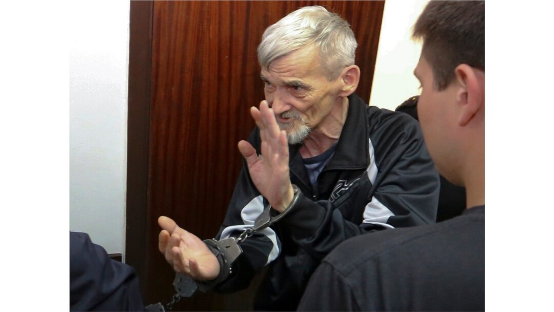 Russian historian Yury Dmitriyev is escorted into a court room in the city of Petrozavodsk, northwestern Russia in Petrozavodsk, Russia, Thursday, June 28, 2018.
