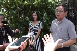 FILE: Pheng Heng, right, lawyer to former Cambodia National Rescue Party's President Kem Sokha, speaks to media in front of Kem Sokha's house in Phnom Penh, Cambodia, Sunday, Nov. 10, 2019.
