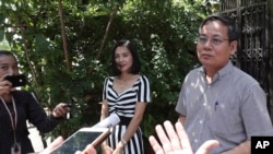 Pheng Heng, right, lawyer to former Cambodia National Rescue Party's President Kem Sokha, speaks to media in front of Kem Sokha's house in Phnom Penh, Cambodia, Nov. 10, 2019.