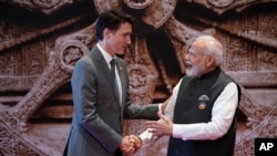 FILE - Indian Prime Minister Narendra Modi welcomes Canada Prime Minister Justin Trudeau upon his arrival at Bharat Mandapam convention center for the G20 Summit, in New Delhi, Sept. 9, 2023.