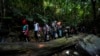 Para kelompok migran, yang didominasi oleh warga Haiti, berjalan menuju ke arah utara melewati area hutan Celah Darien (Darien Gap) di Kolombia, pada 15 September 2021. (Foto: AP/Fernando Vergara)