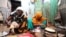 An internally displaced Somali woman and her daughter prepare their Iftar meal during the month of Ramadan at the Shabelle makeshift camp in the Hodan district of Mogadishu, Somalia, May 8, 2020.