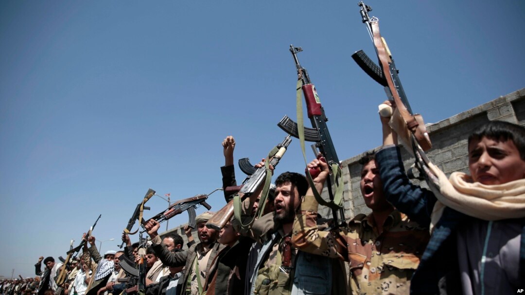 FILE - Tribesmen loyal to Houthi rebels hold their weapons and chant slogans during a gathering aimed at mobilizing more fighters into battlefronts in several Yemeni cities in Sana'a, Oct. 2, 2016. 