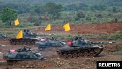 FILE - Taiwan tanks roll on the "battlefield" during the annual Han Kuang military exercise in Hukou, Hsinchu County about 50 km (30 miles) south of the capital Taipei, May 17, 2007.