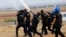 Turkish riot police fire tear gas to disperse pro-Kurdish protesters near the Turkish-Syrian border in the southeastern town of Suruc in Sanliurfa province, Sept. 29, 2014.