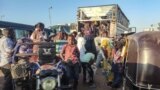 FILE - People displaced by the conflict in Sudan get in their transporation as they flee Wad Medani, the capital of al-Jazeera state, heading to Gadaref state on December 16, 2023.